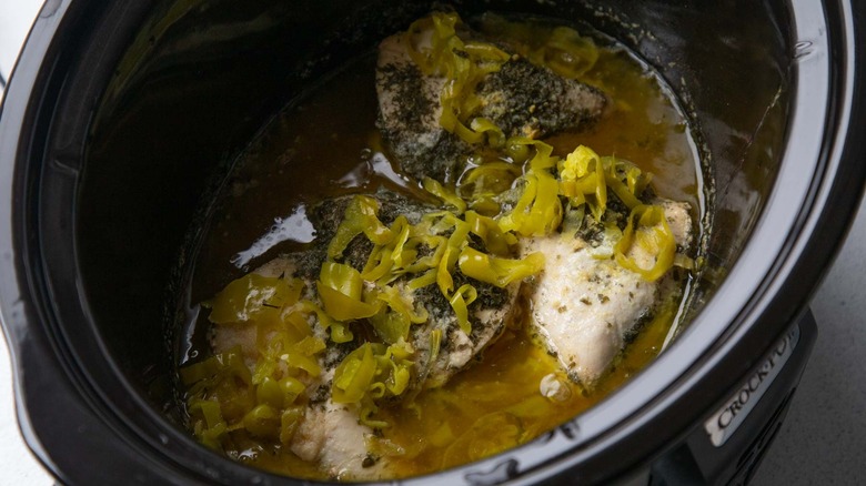 Cooked chicken breasts with stock in slow cooker