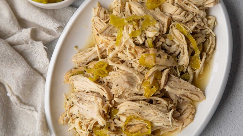 Plate with shredded Mississippi chicken and pepperoncini