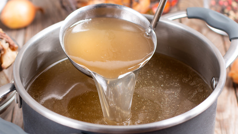 Broth being ladled out of pot