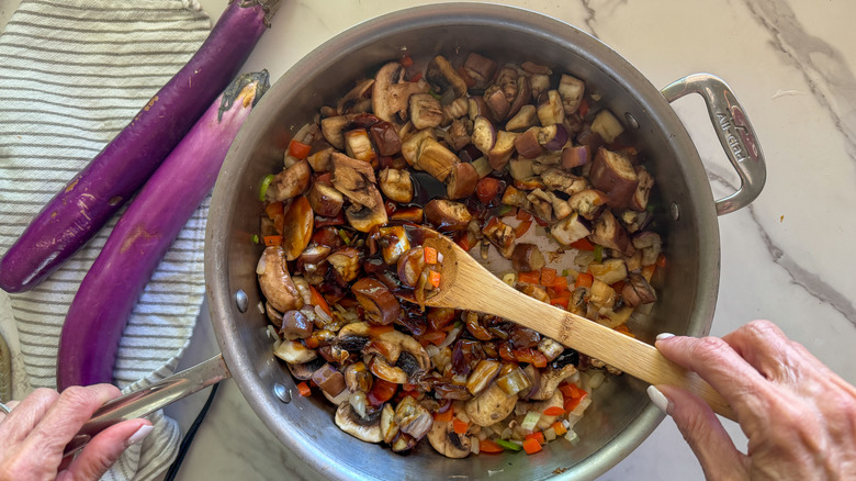 stirring finished stir-fry in pan