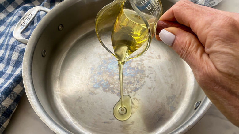 adding oil to pan