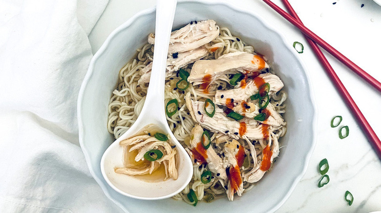 chicken noodle soup with ladle spoon