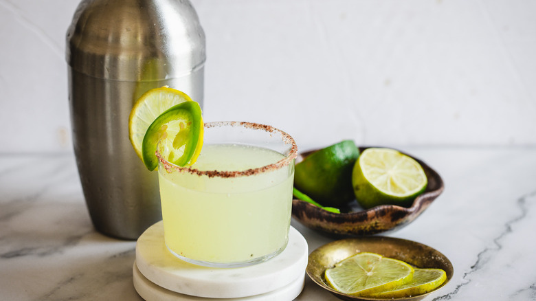 spicy margarita with limes and shaker