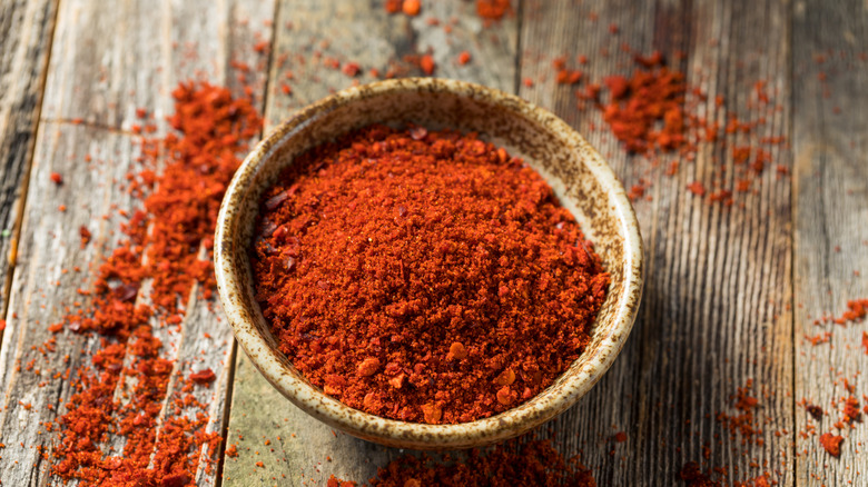 sriracha seasoning in bowl with wood background