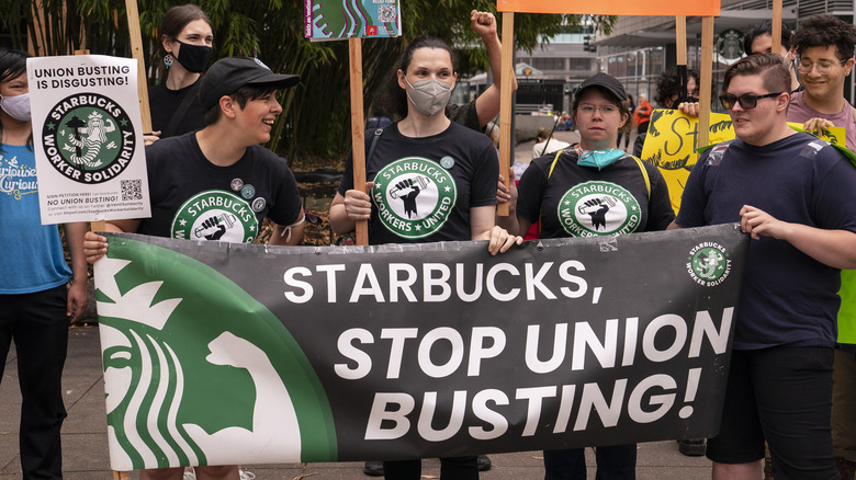 protestors holding Starbucks union signs