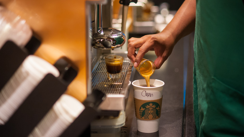 barista making espresso drink at Starbucks