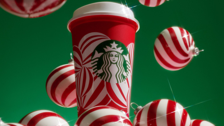 Starbucks 2024 Red Cup with red and white ornaments and green background