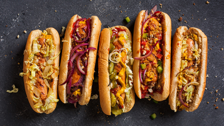 Hot dogs covered in various toppings