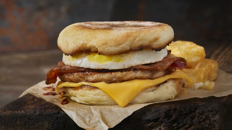 breakfast sandwich with egg, sausage and bacon