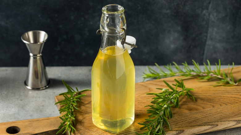 flavored simple syrup with jigger and rosemary