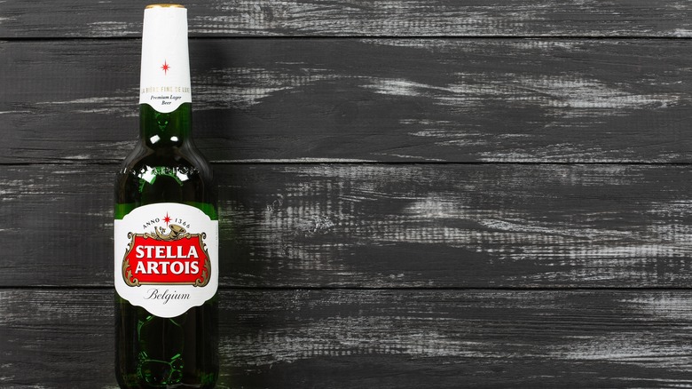 Bottle of Stella Artois on a grey wooden background