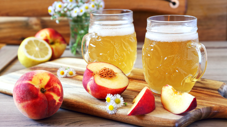 peaches and beer on a wooden board