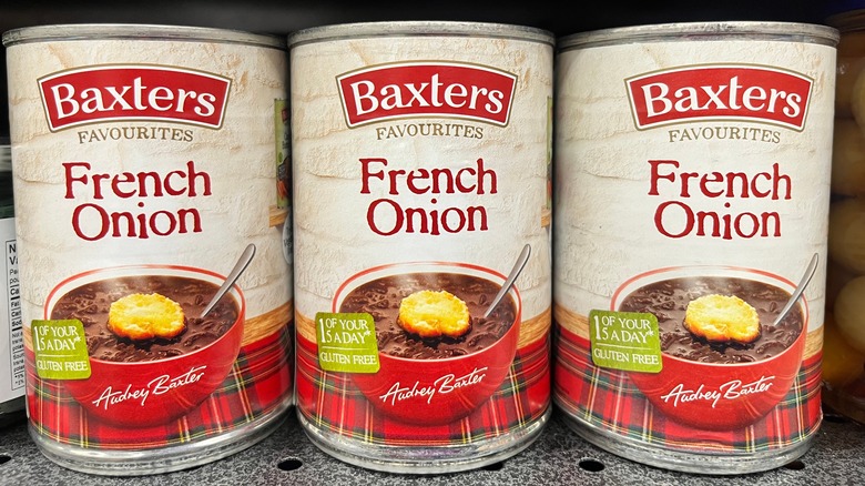 Cans of soup on grocer's shelf