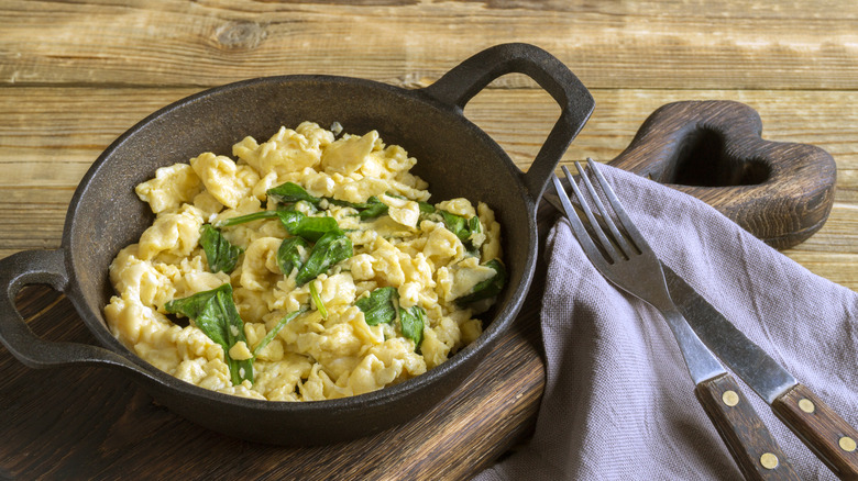 cast iron pan with scrambled eggs