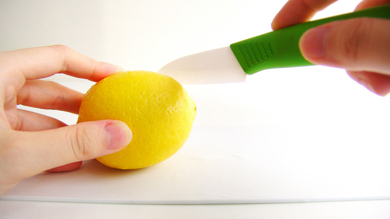 cutting into a lemon