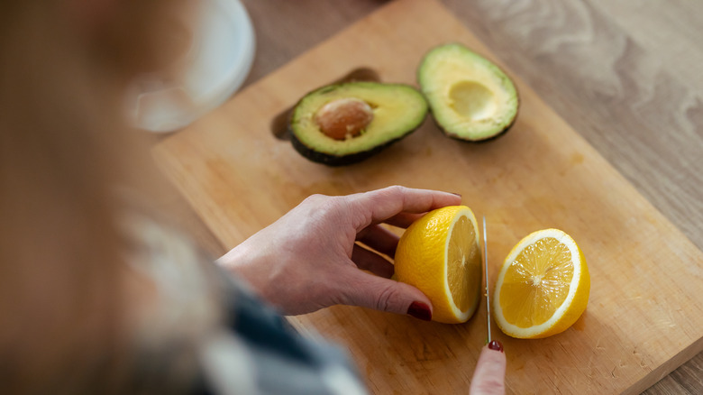 slicing lemon by an avocado