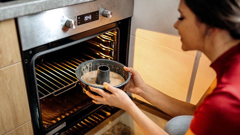 putting a cake in the oven