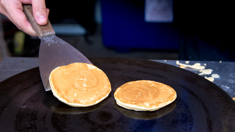 A person flipping a pancake