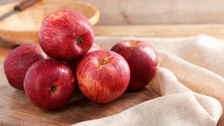 fresh apples on top of a cutting board