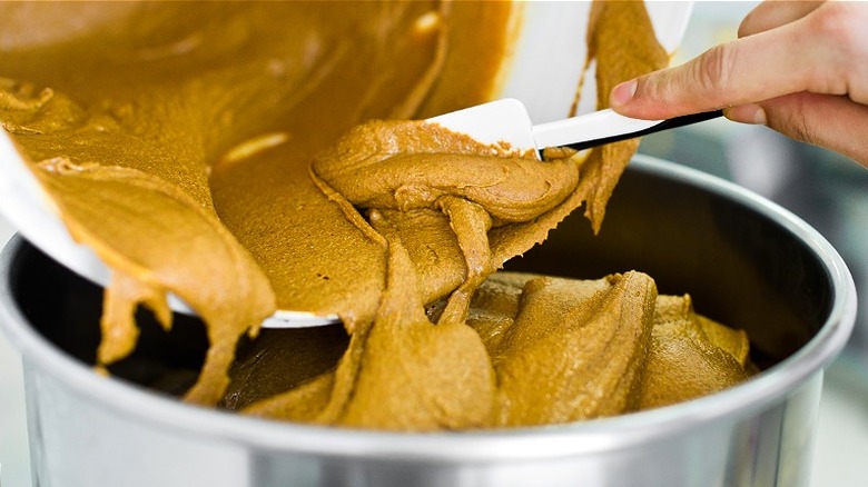 Trasnferring peanut butter with spatula