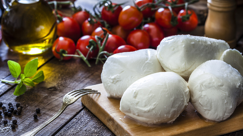 Tomatoes and cheese on a wooden table