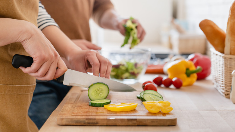 chopping cucumbers for salad