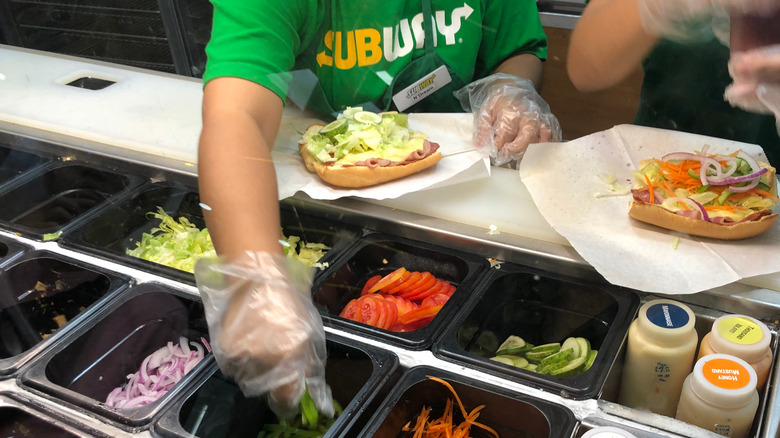 Subway worker preparing food