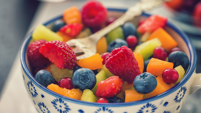 Fruit salad in a bowl with strawberries, mango, blueberries