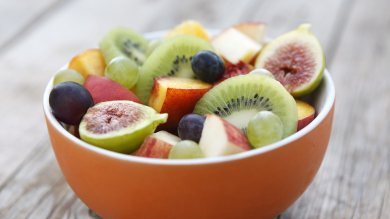 Orange bowl filled with fresh fruit salad