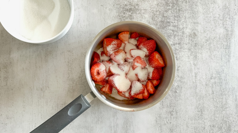 strawberries sugar water in saucepan