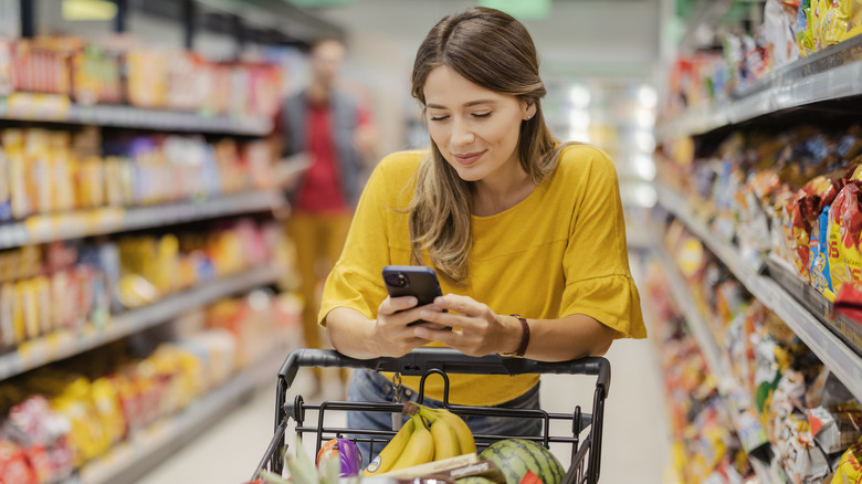 customer checking phone while shopping