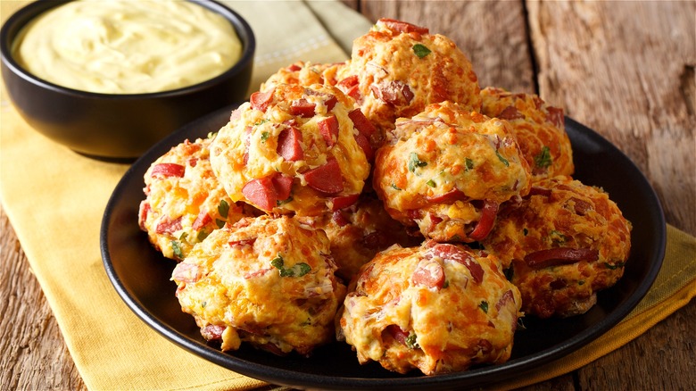 Sausage cheese and pepper snack balls piled on a plate