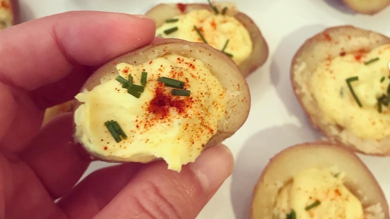 Person holding deviled potato