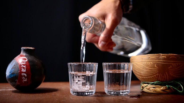 mezcal pouring into shot glasses