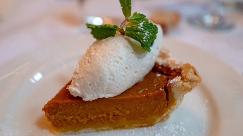 pumpkin pie slice with whipped cream