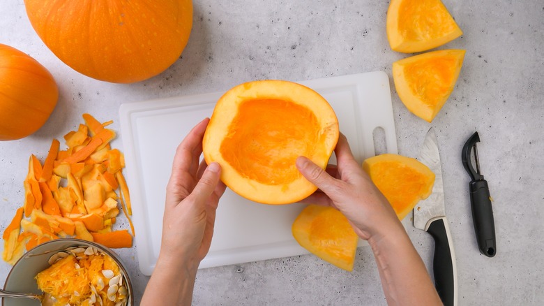 hand peeling raw pumpkin