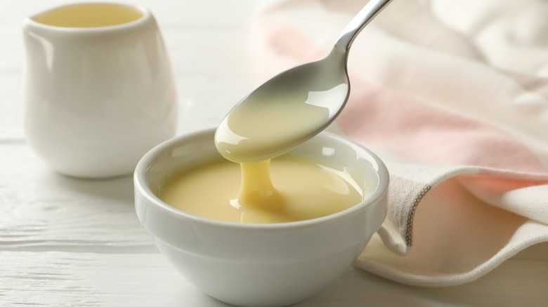 Condensed milk getting spooned in bowl