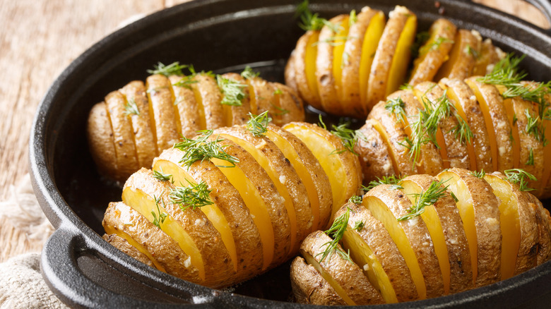 Hasselback potatoes in a pan on a table