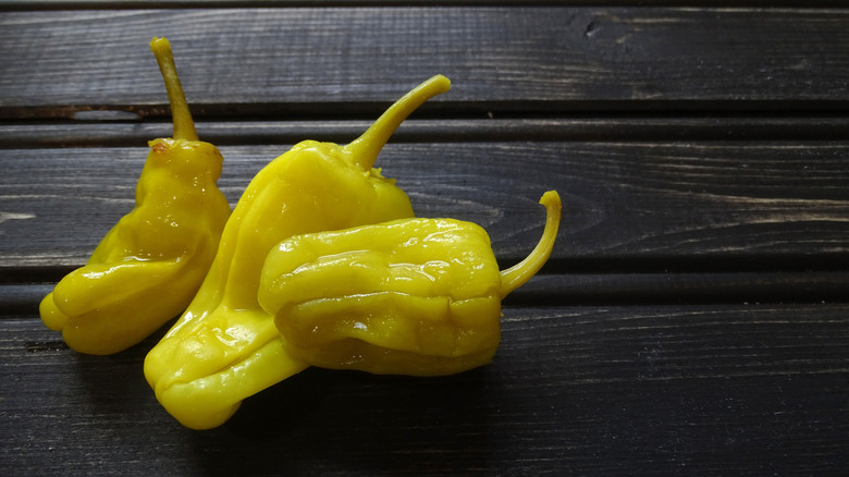 Fresh pepperoncini on a dark wood background