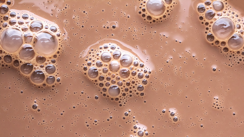 Close up of chocolate milk with bubbles on the surface