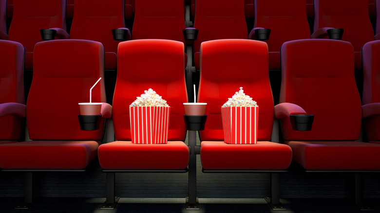 Empty movie theater seats with popcorn and soda