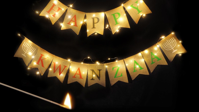 Happy Kwanzaa banner with a lit match