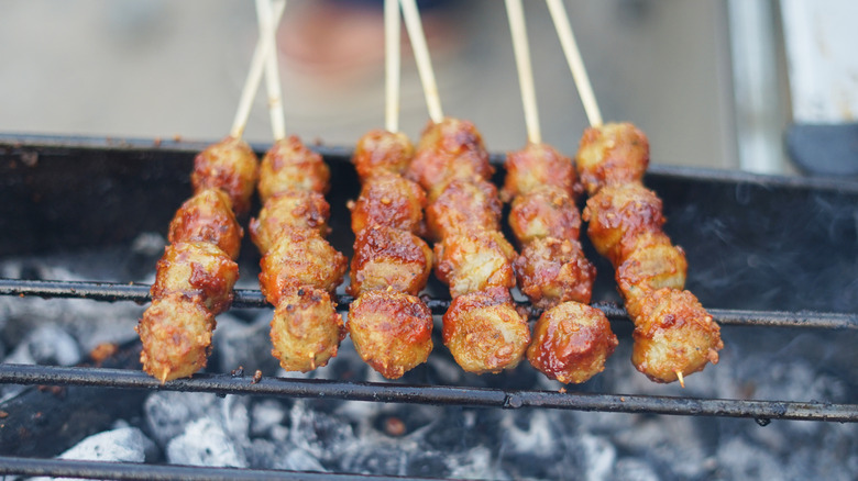 Skewered meatballs on a grill