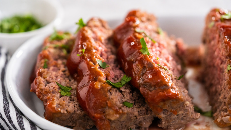 Cooked meatloaf in a dish.