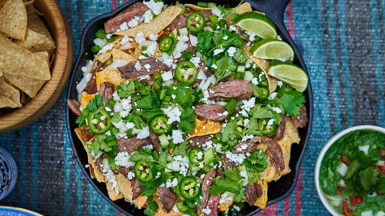 Nachos with toppers in skillet