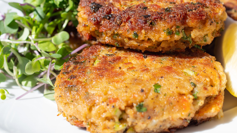 Pair of crab cakes with sprouts