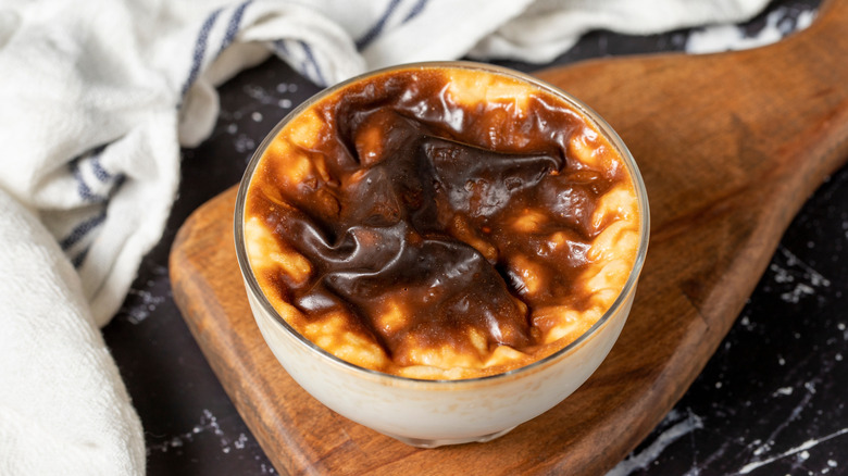 rice pudding with a brown crust on wooden board