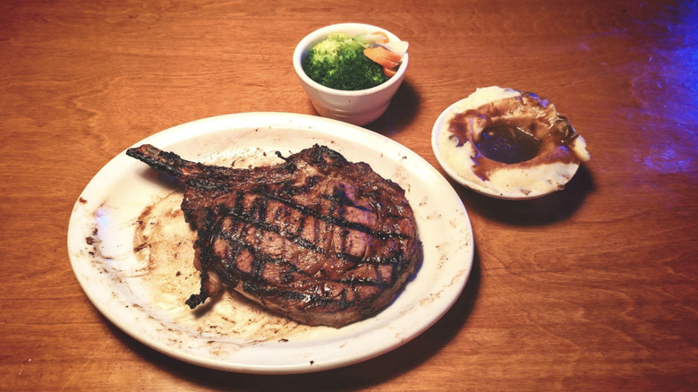 Texas Roadhouse bone-in ribeye with sides