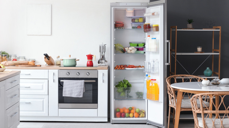 open refrigerator in clean and organized kitchen