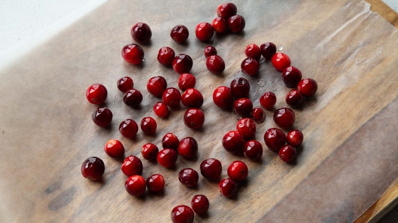 Damp cranberries on a wooden plank